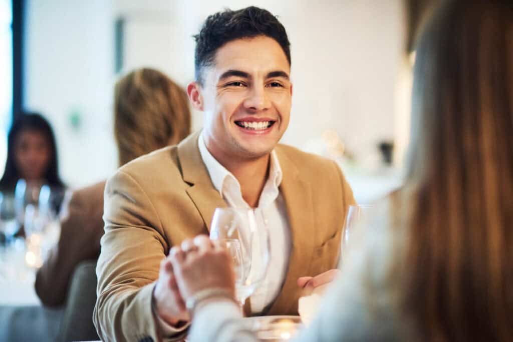 A man on a date with a woman and he is head over heels